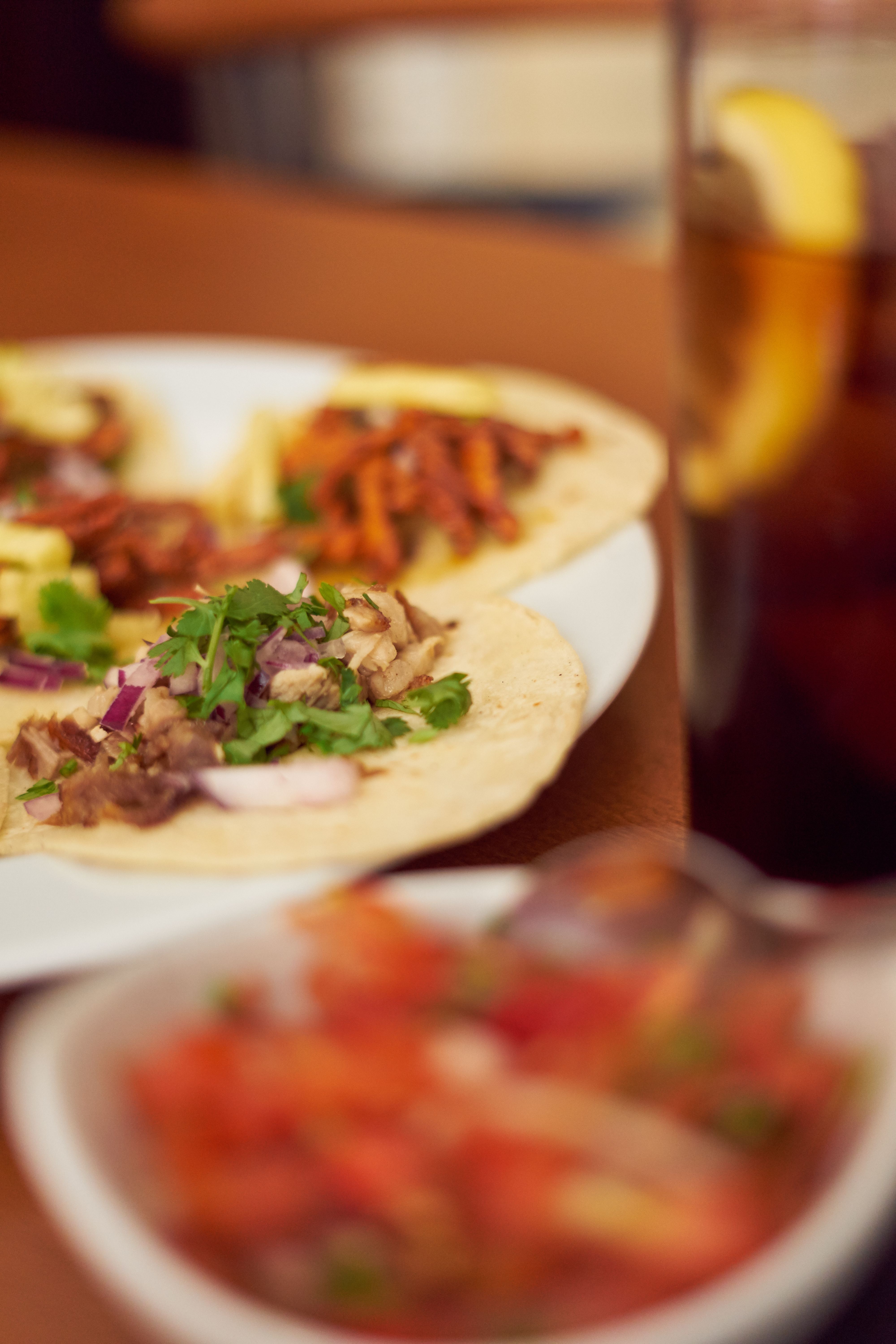 Mexican Tacos "Pastor" and "Carnitas" with pork and beef in yellow tortilla